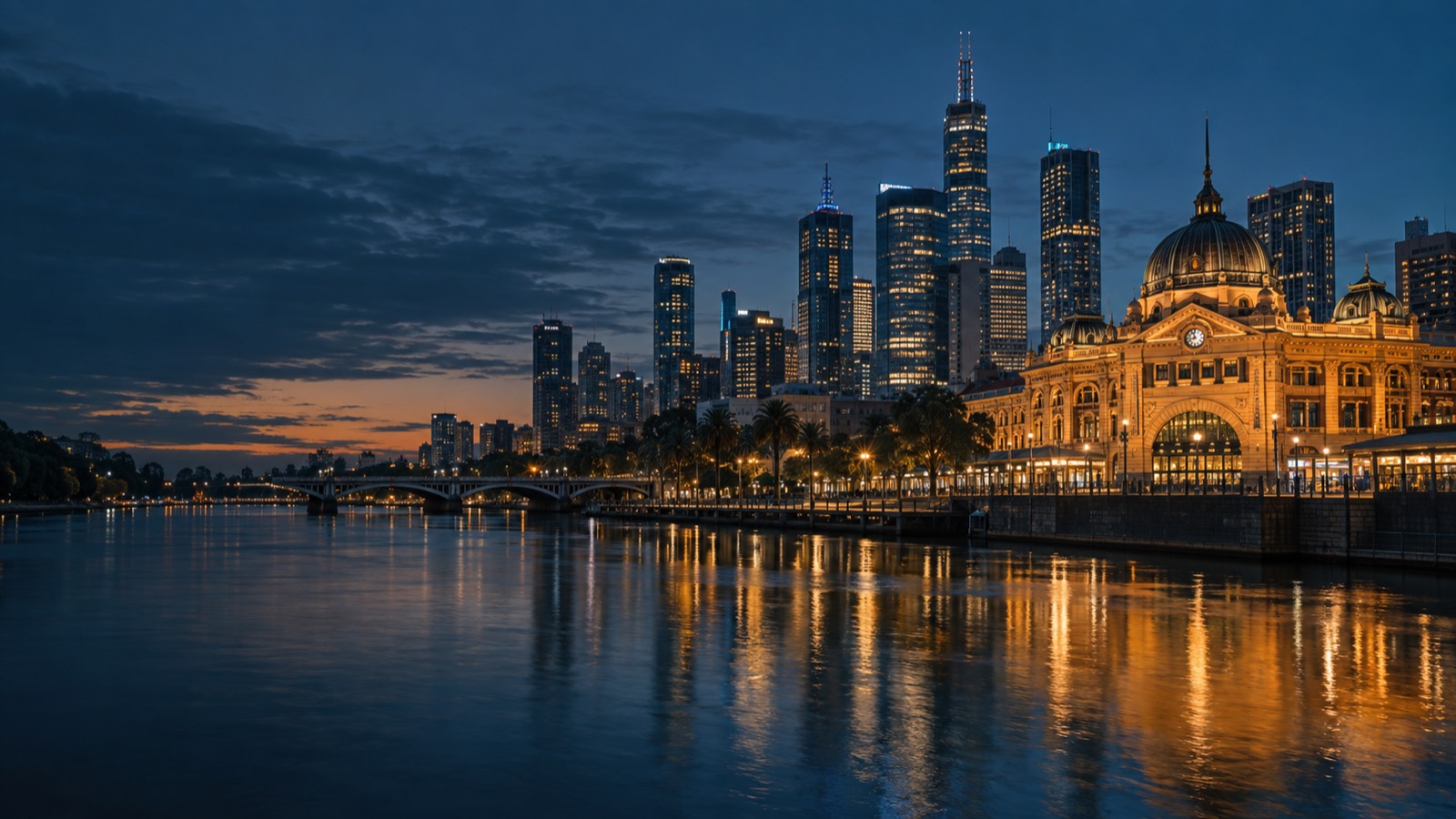 Melbourne's skyline and Flinders Street Station over the Yarra at blue hour